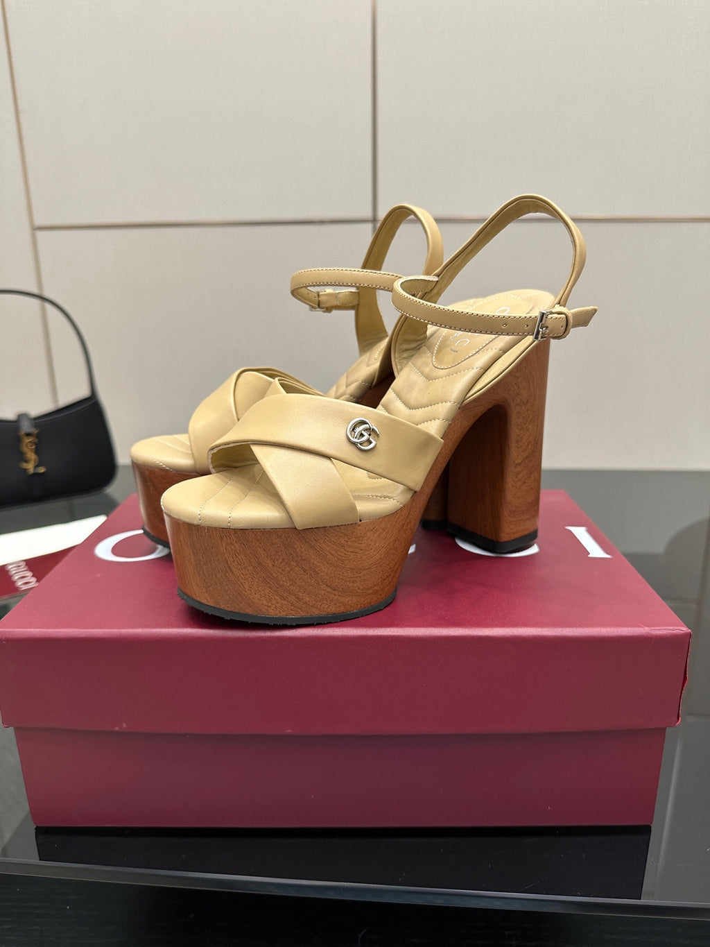 Gucci women's platform sandals, cream leather slingback straps with wood-tone block heel.