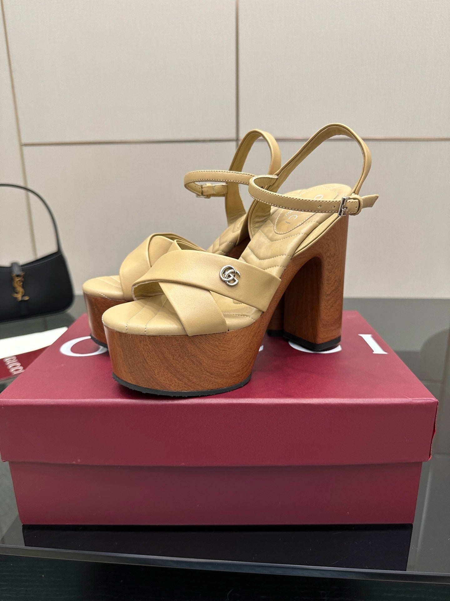 Gucci women's platform sandals, cream leather slingback straps with wood-tone block heel.