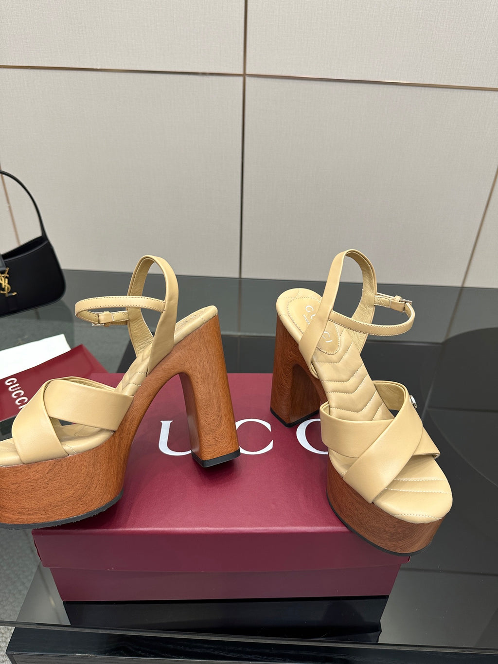 Gucci women's platform sandals, cream crossover straps with tall wood-tone block heels and platform.