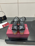 Gucci black platform heeled sandals with crisscross straps and wood-look block heel