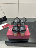Gucci black platform heeled sandals with crisscross straps and wood-look block heel