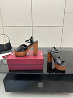Gucci black platform heeled sandals on display with wood-look platform and block heel