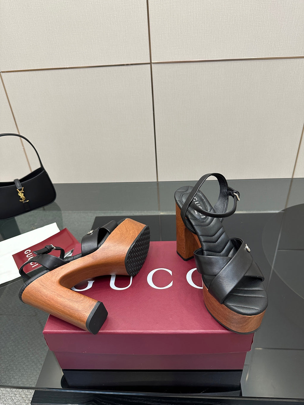 Gucci black platform heeled sandals with crisscross straps and wood-look platform heel