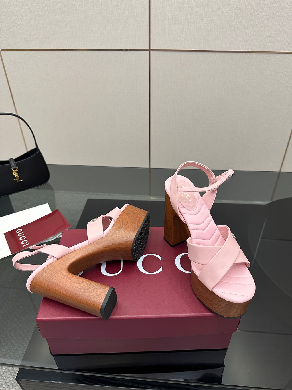 Pink platform sandals with open toe and wooden block heels, side-by-side on display