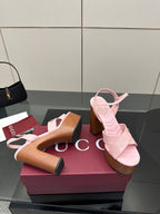 Pink platform sandals with open toe and wooden block heels, side-by-side on display