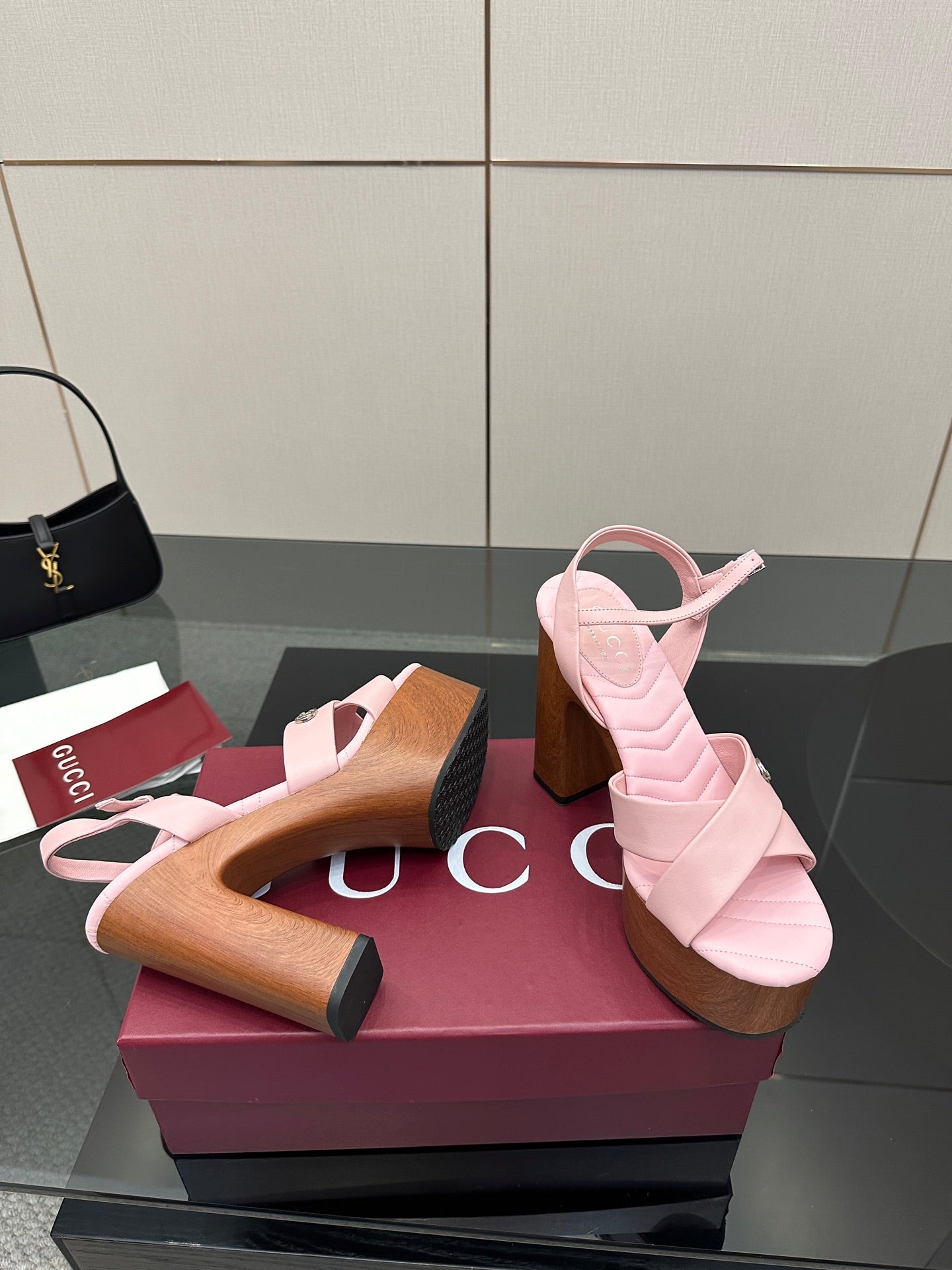 Pink platform sandals with open toe and wooden block heels, side-by-side on display