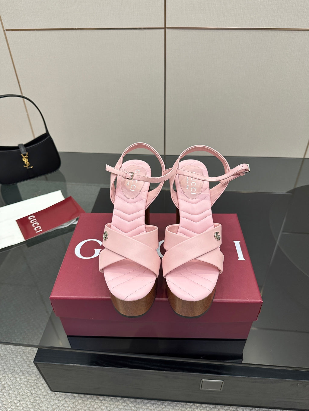 Pink platform sandals with thick cross straps and a chunky wooden block heel