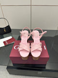 Pink platform sandals with thick cross straps and a chunky wooden block heel