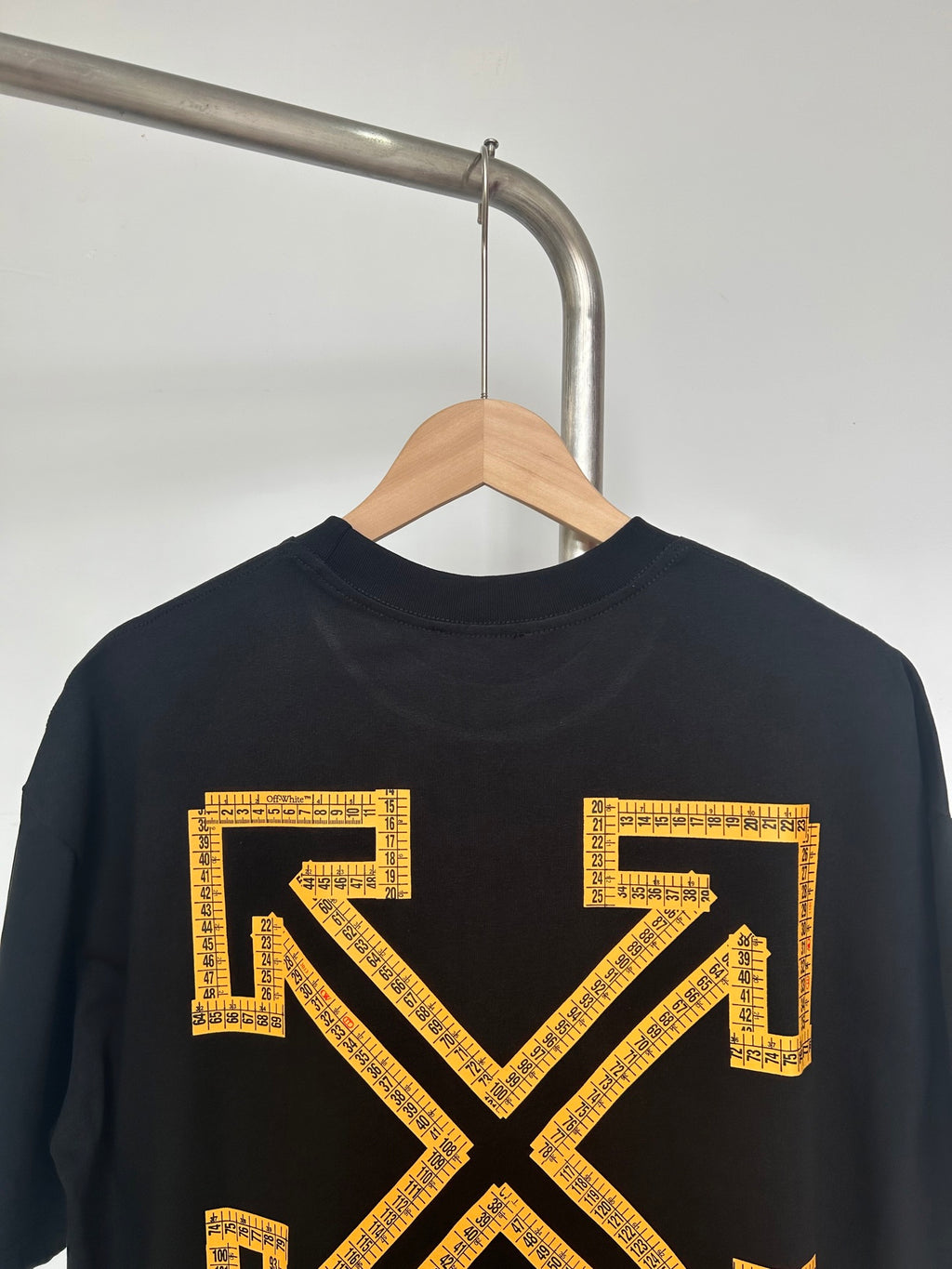 Black Off-White T-shirt closeup with yellow arrow X graphic