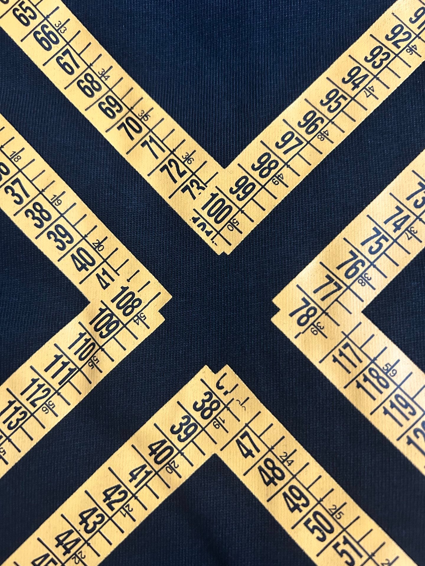 Off-White arrow graphic and numbers pattern on dark T-shirt fabric