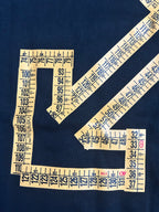 Off-White arrow graphic and numbers on dark T-shirt fabric