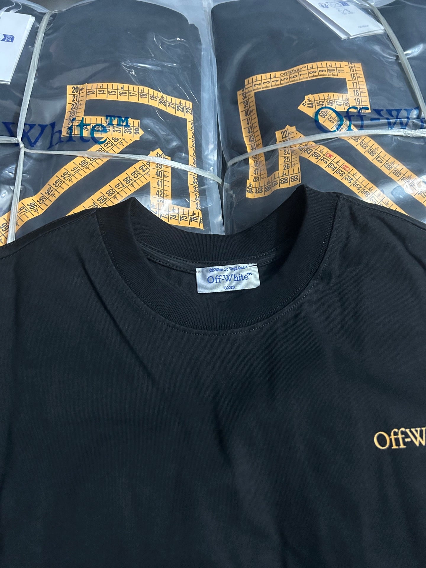 Off-White crewneck T-shirt with gold graphic detail and logo label