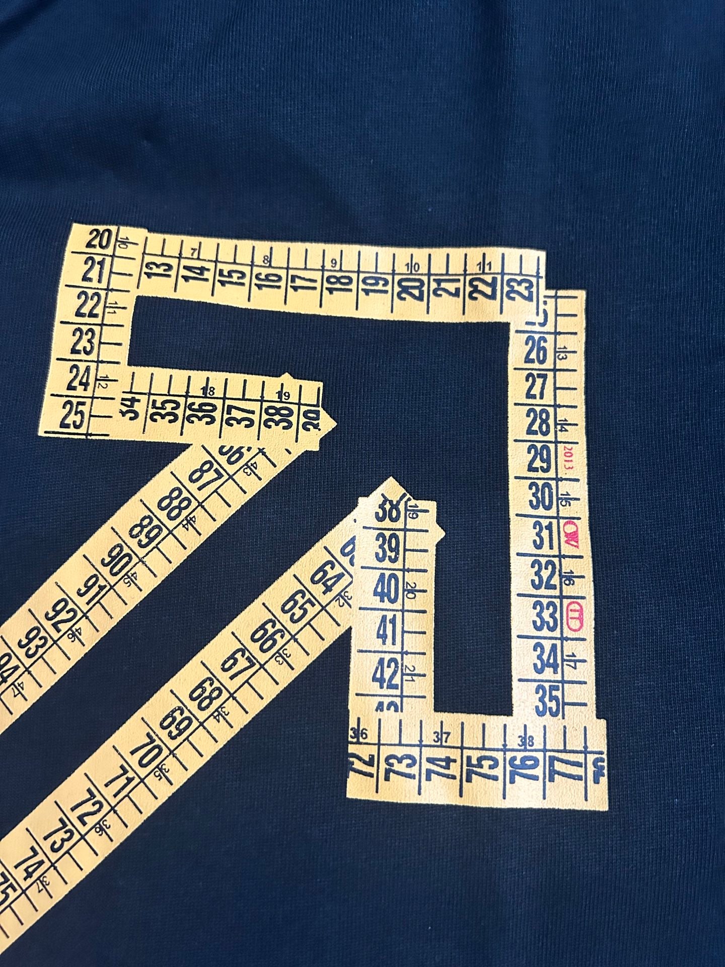 Off-White arrow and numbers graphic print on dark T-shirt fabric