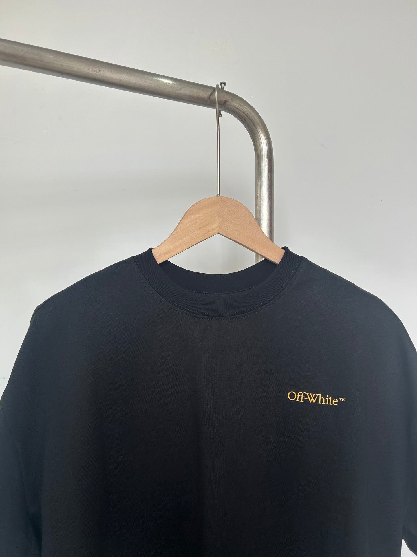 Dark T-shirt neckline with small Off-White™ chest logo