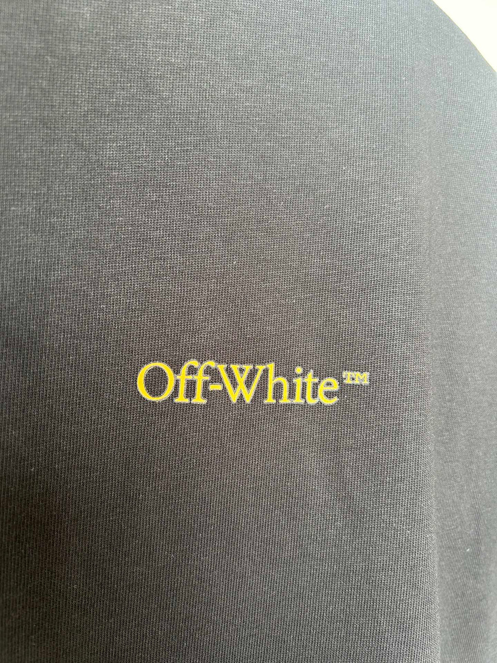 Off-White™ yellow logo on dark T-shirt fabric
