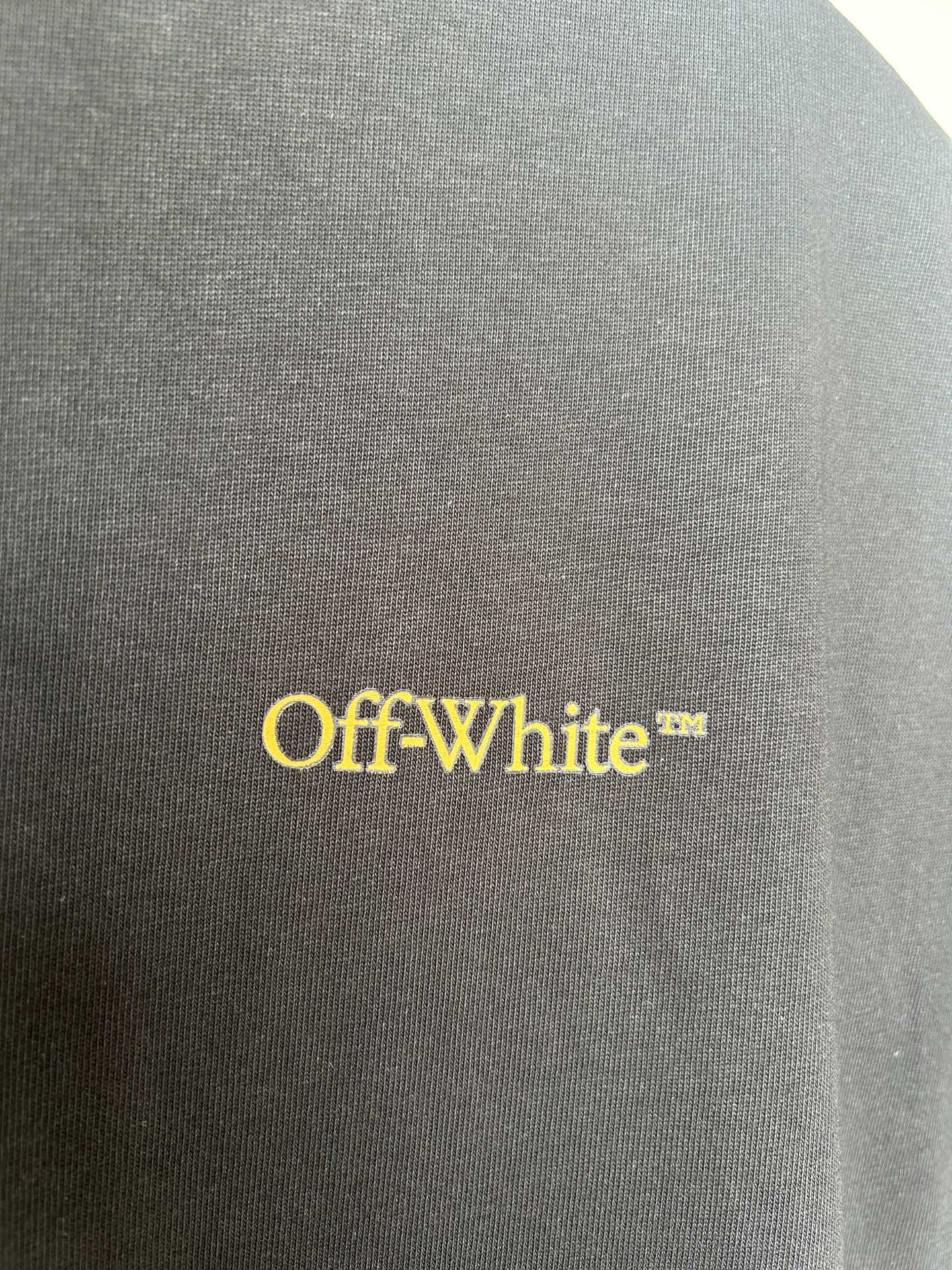 Off-White™ yellow logo on dark T-shirt fabric