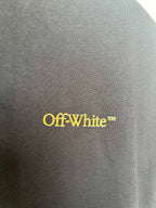Black T-shirt fabric closeup with yellow Off-White logo text