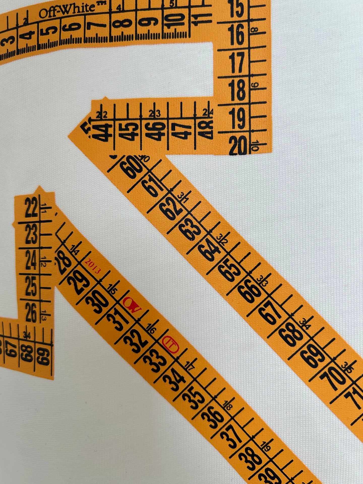 Off-White off-white T-shirt close-up of orange ruler-style lines and numbers
