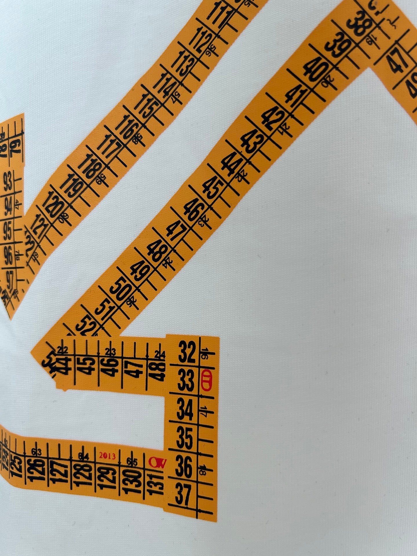 Off-White off-white T-shirt close-up of orange measurement logo lines and numbers