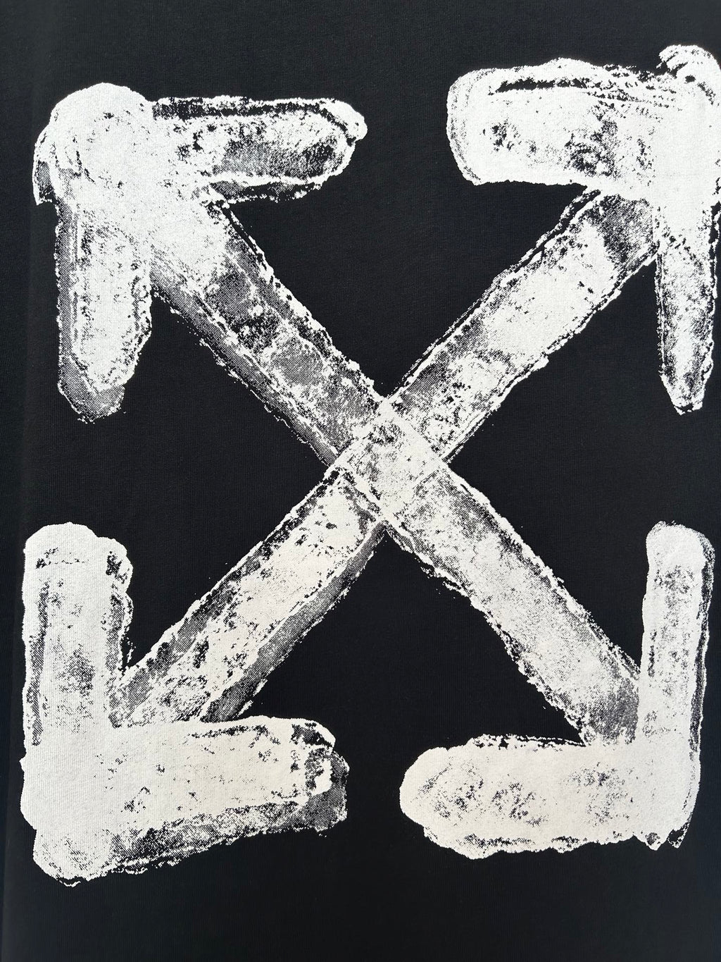 Black T-shirt close-up of off-white distressed X and arrows graphic