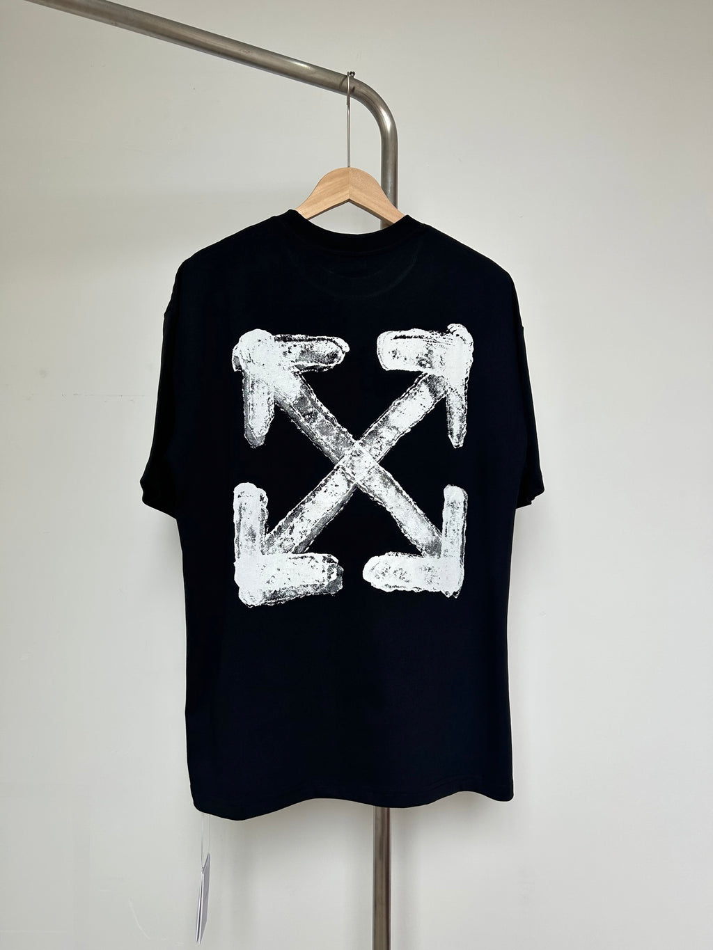 Black T-shirt with large off-white distressed X-shaped graphic on chest