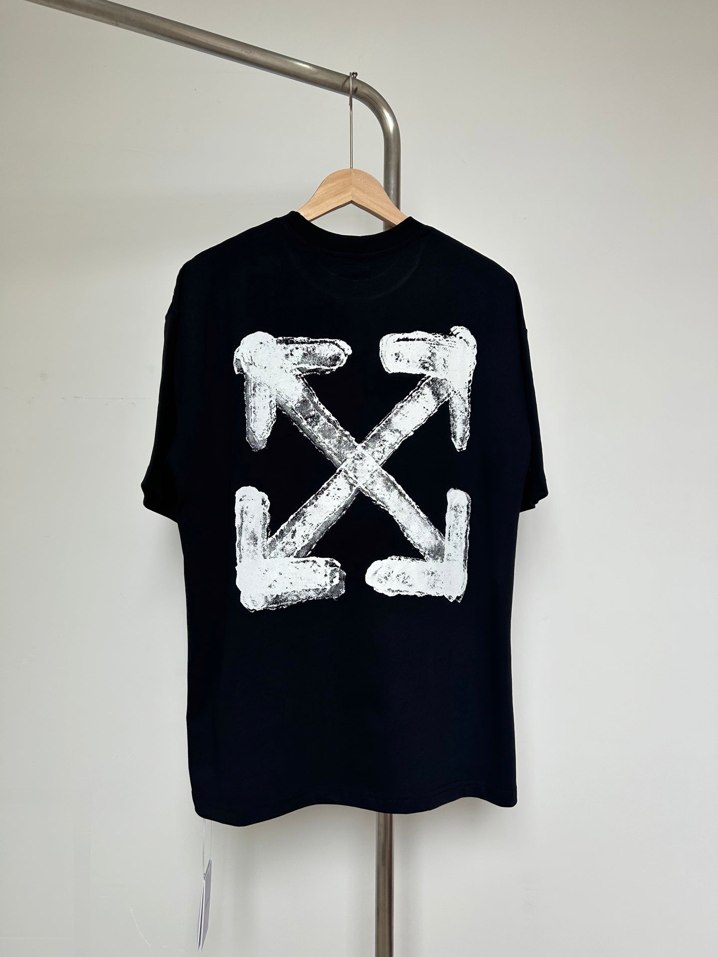Black T-shirt with large off-white distressed X-shaped graphic on chest