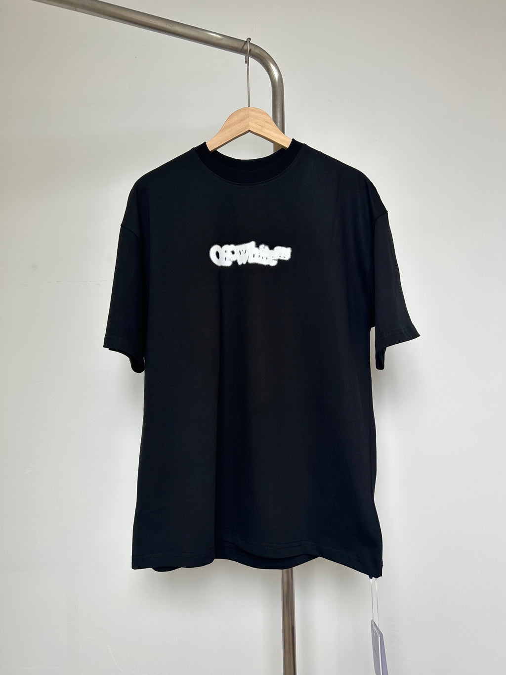 Black T-shirt with small off-white logo graphic on chest