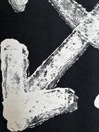 Black T-shirt close-up of off-white distressed left arrow graphic