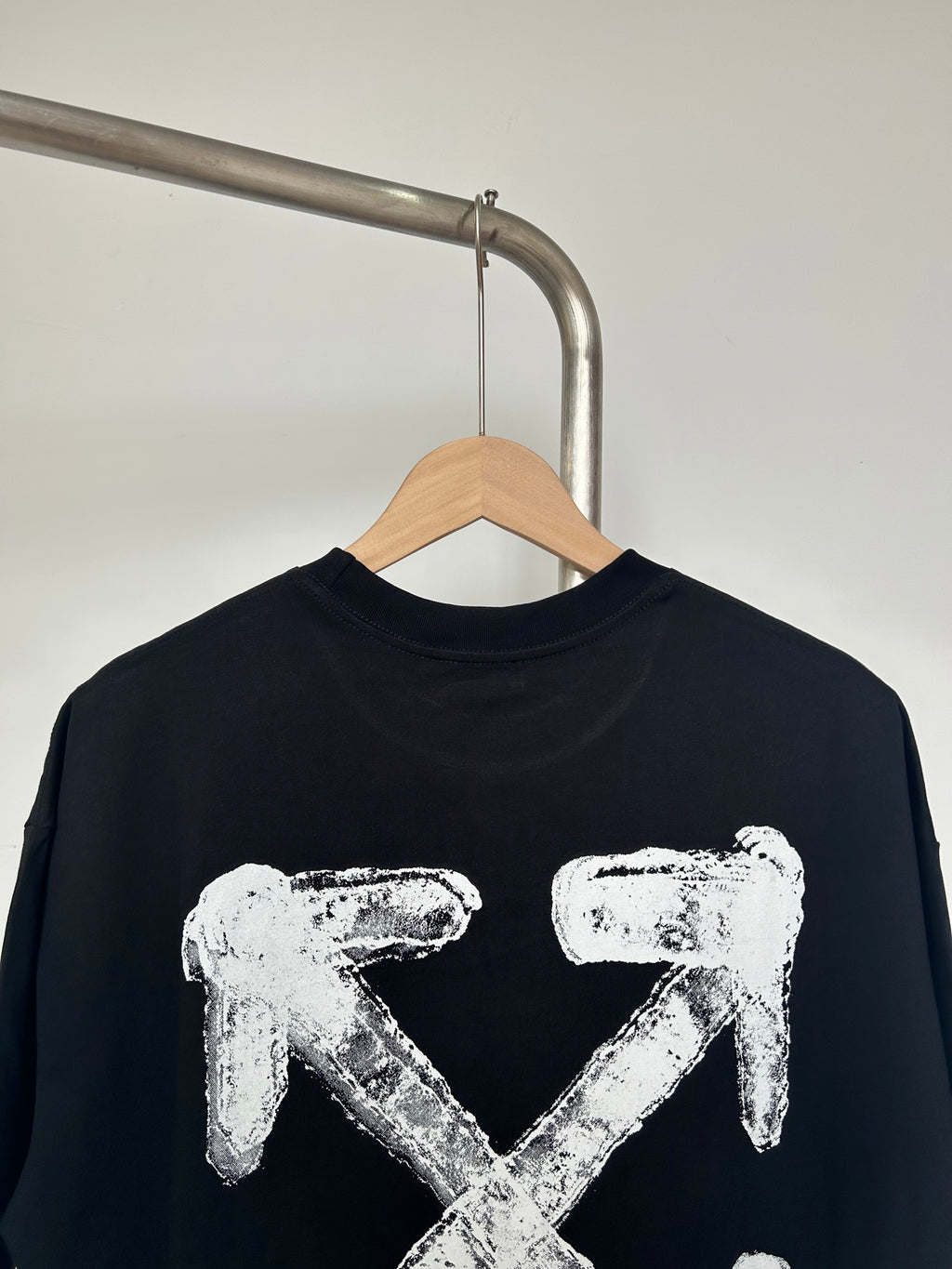 Black T-shirt with centered off-white X-shaped graphic print