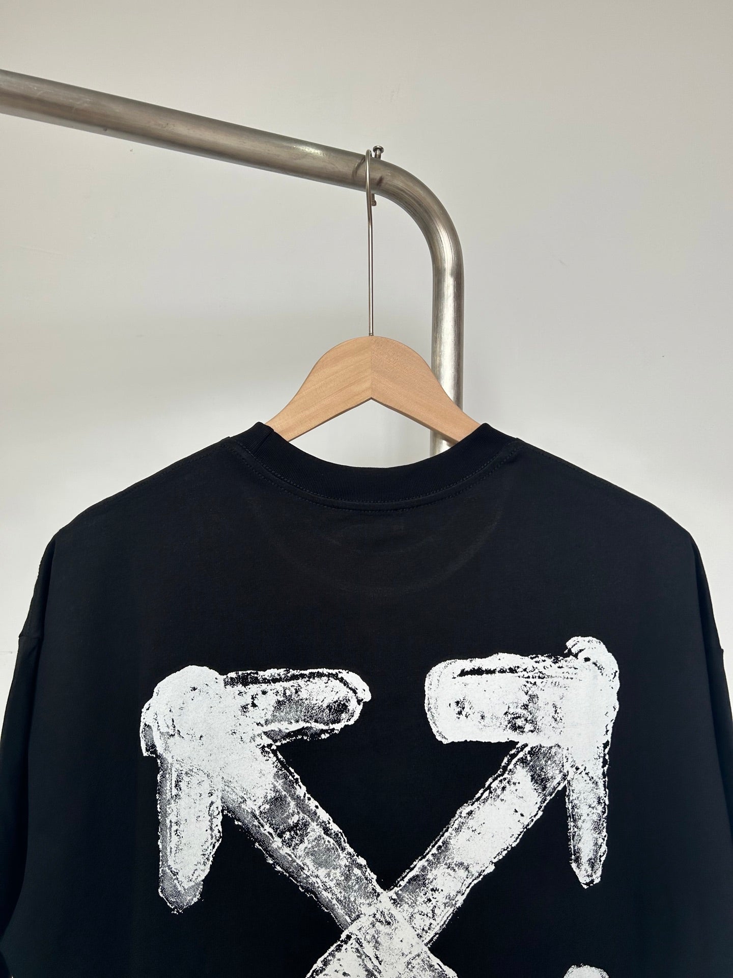 Black T-shirt with centered off-white X-shaped graphic print