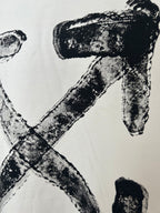 Off-white T-shirt close-up of black logo X and letter strokes