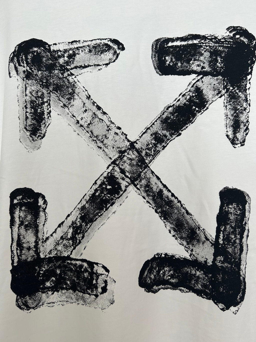 Off-white T-shirt with large black X-shaped logo print, textured ink