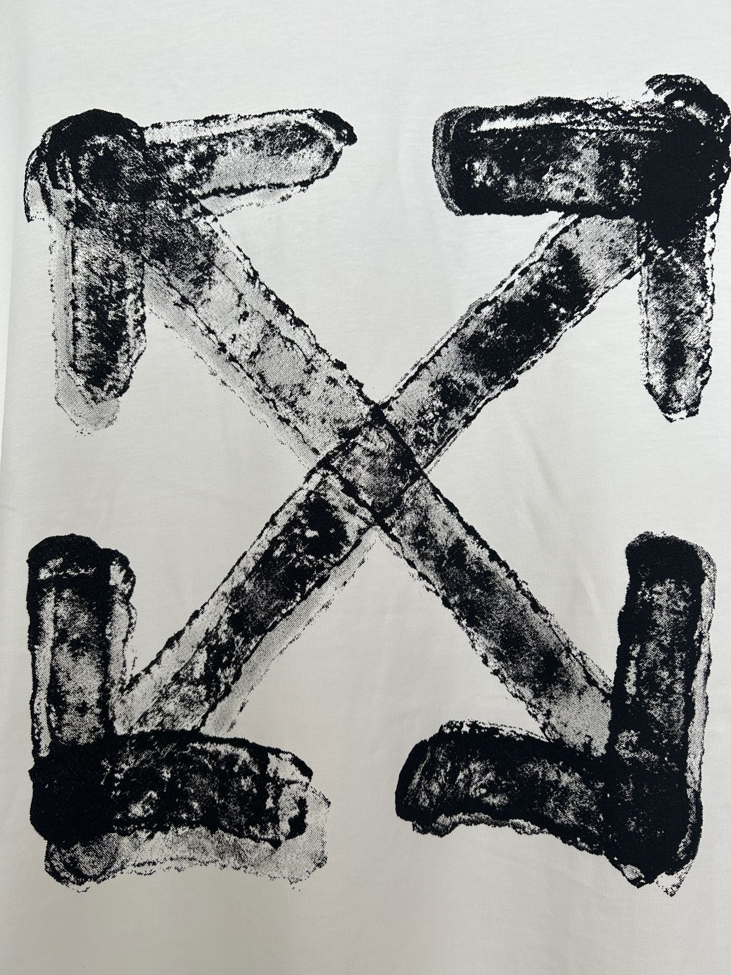 Off-white T-shirt with large black X-shaped logo print, textured ink
