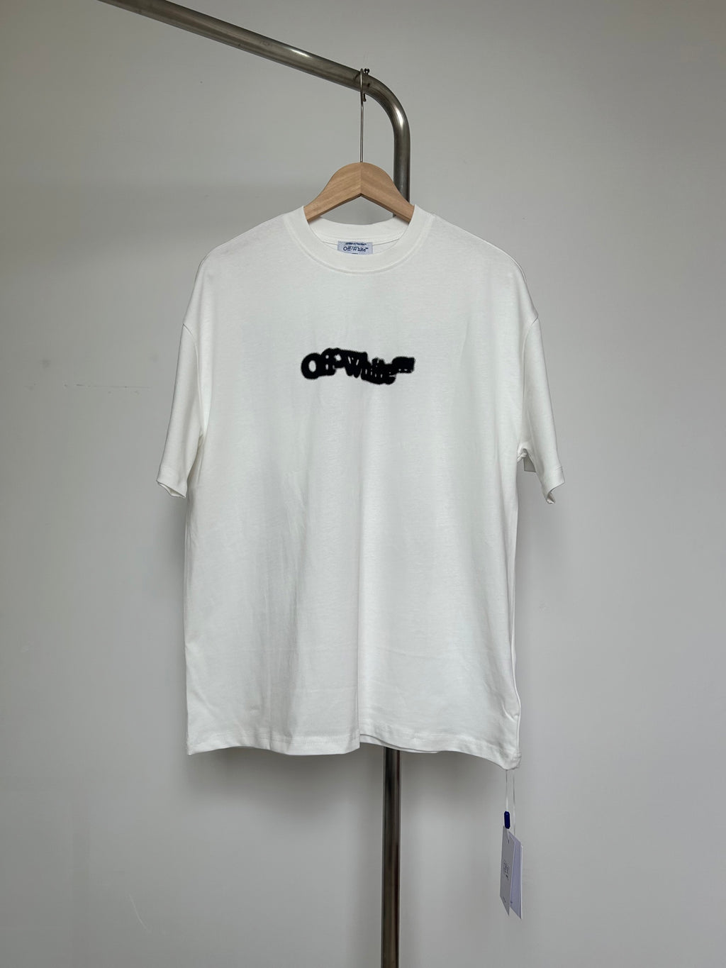 Off-white graphic T-shirt with black logo front, short sleeves