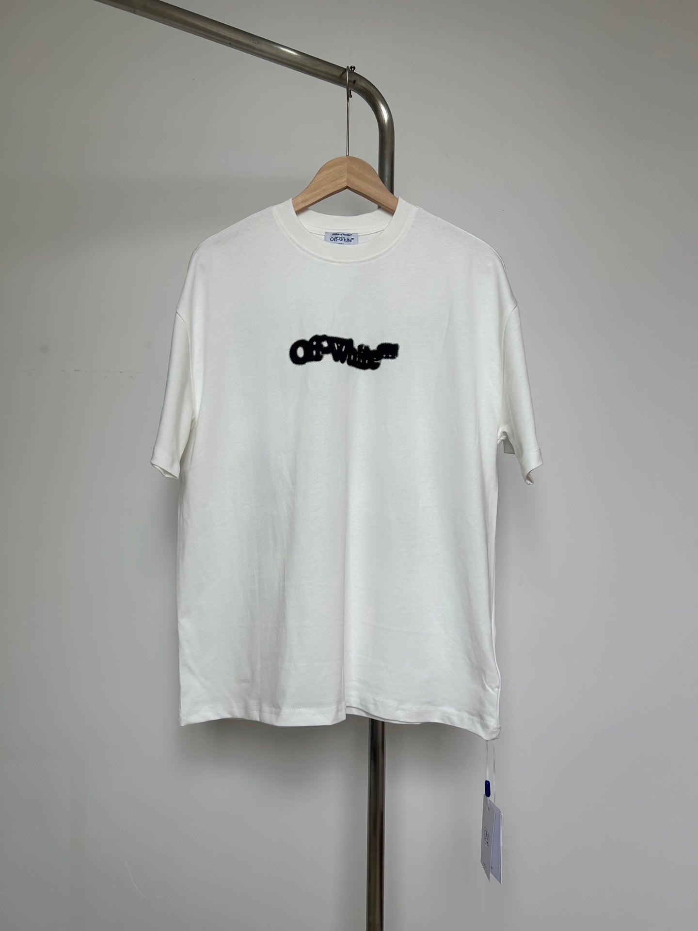 Off-white graphic T-shirt with black logo front, short sleeves