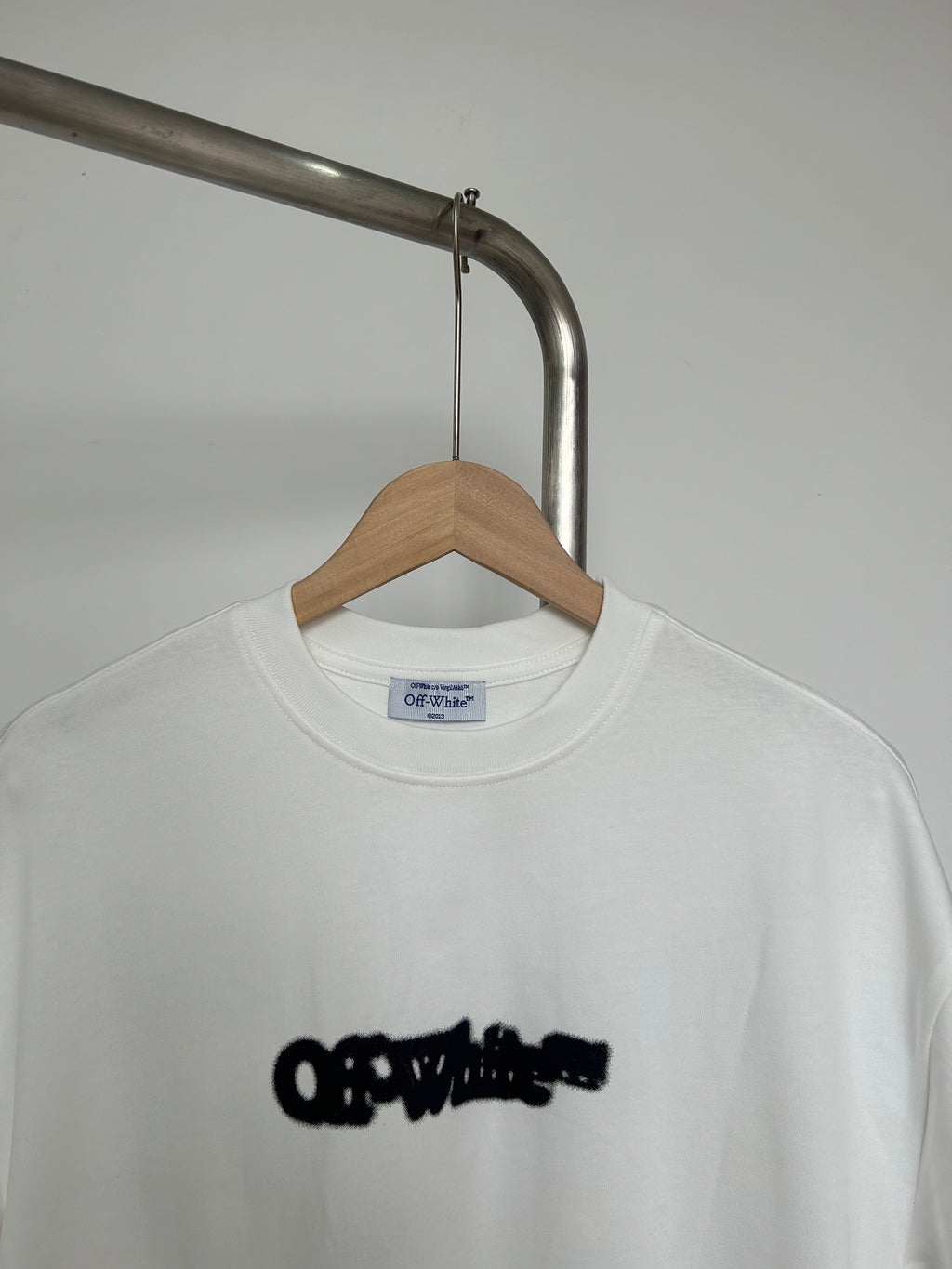 Off-white graphic T-shirt close-up of black logo on chest