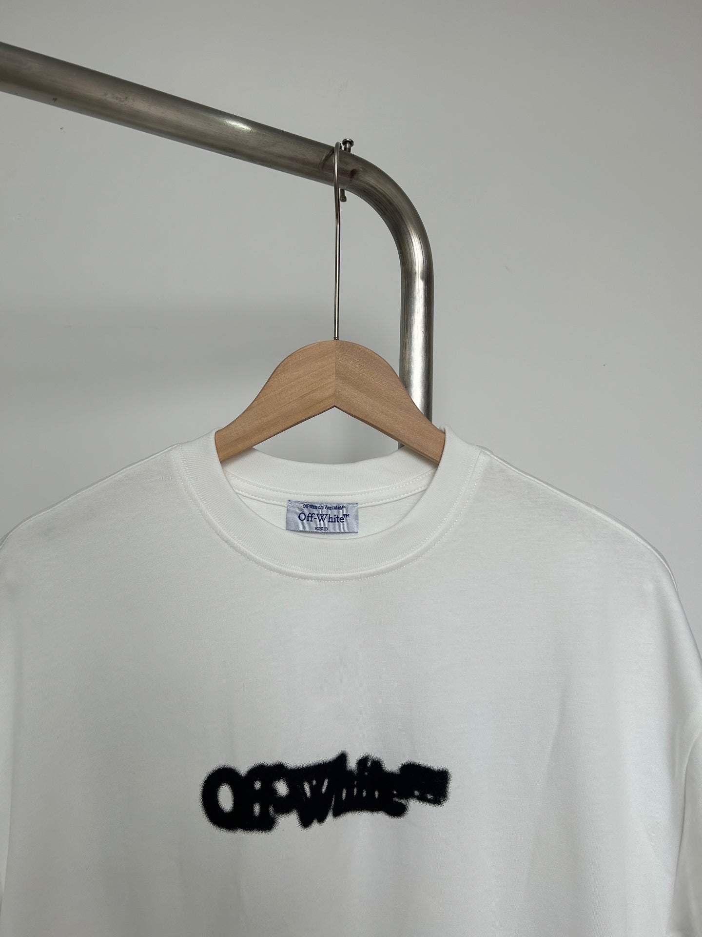 Off-white graphic T-shirt close-up of black logo on chest