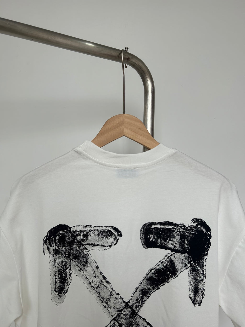 Off-white graphic T-shirt close-up of large black X-shaped logo print