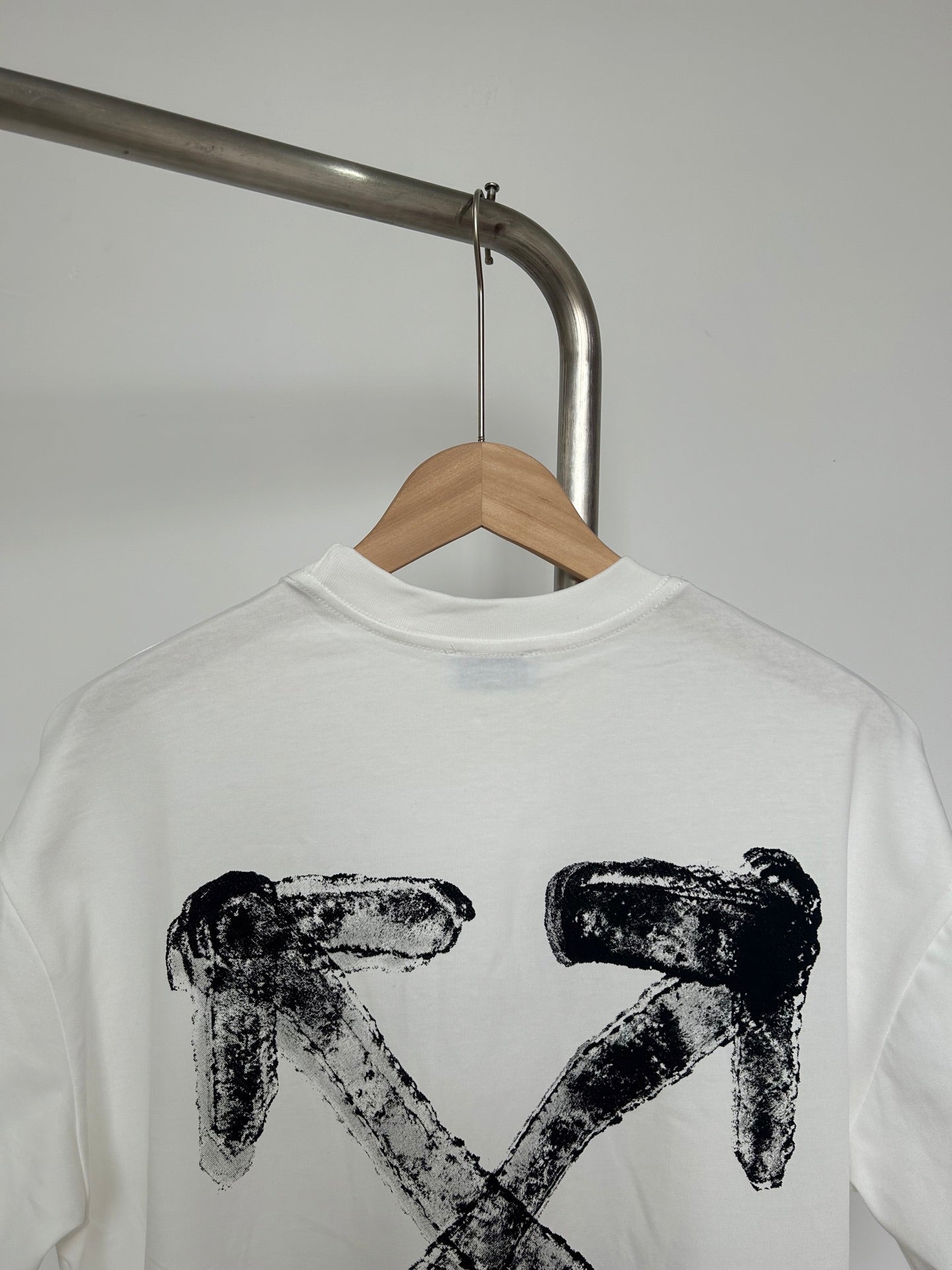 Off-white graphic T-shirt close-up of large black X-shaped logo print