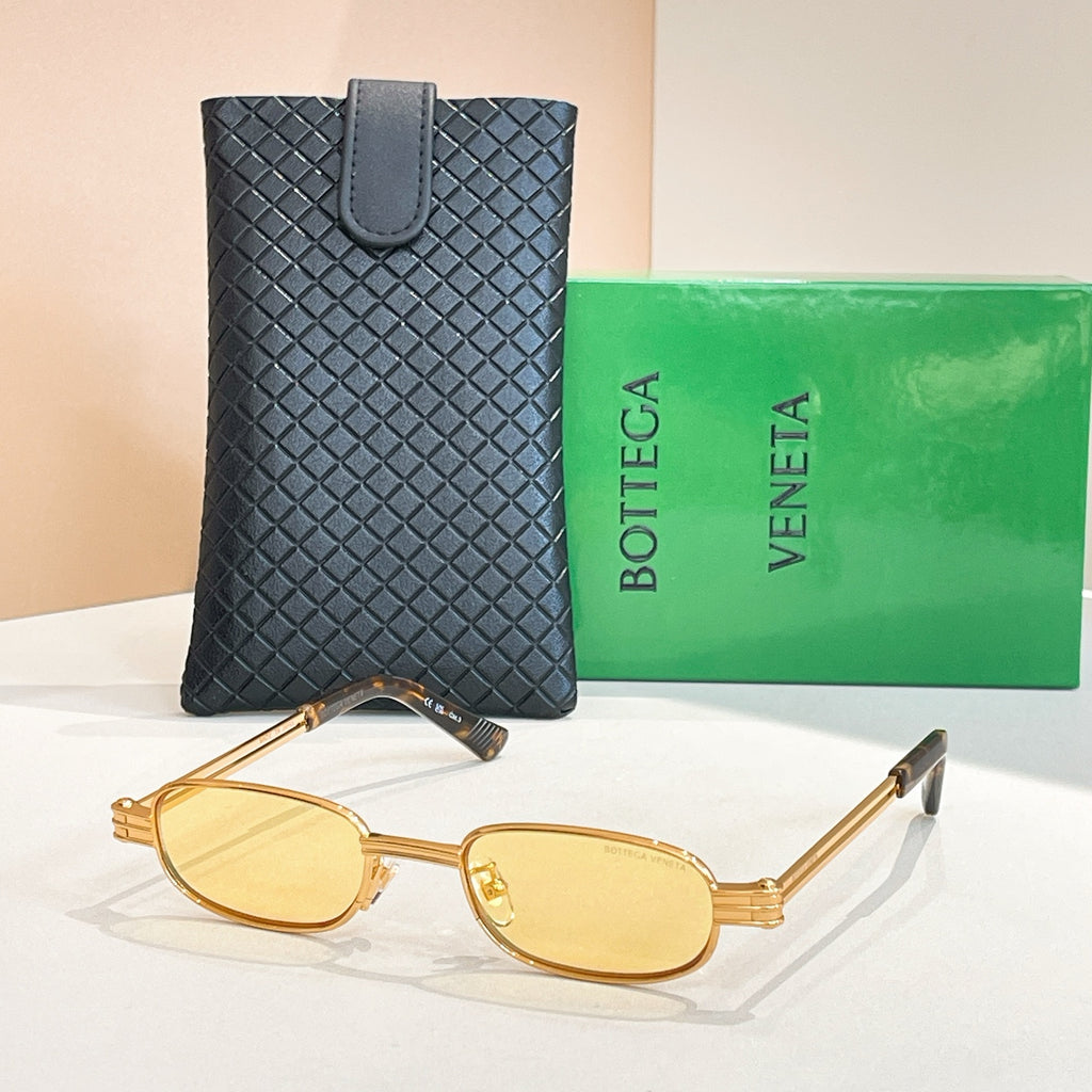 Bottega Veneta oval sunglasses, gold frame with amber-tinted lenses