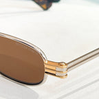Bottega Veneta sunglasses close-up, gold hinge and engraved lens surface
