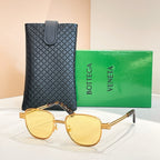 Bottega Veneta sunglasses with yellow lenses, gold-tone round frame and arms.