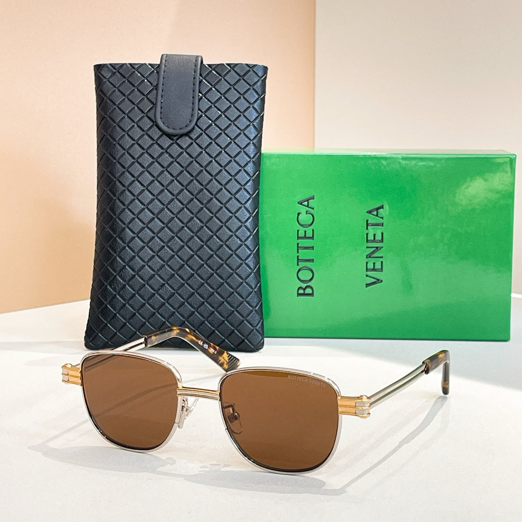 Bottega Veneta sunglasses with warm brown lenses, gold-tone round frame and arms.