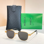 Bottega Veneta sunglasses with dark lenses, gold-tone round frame and extended arms.