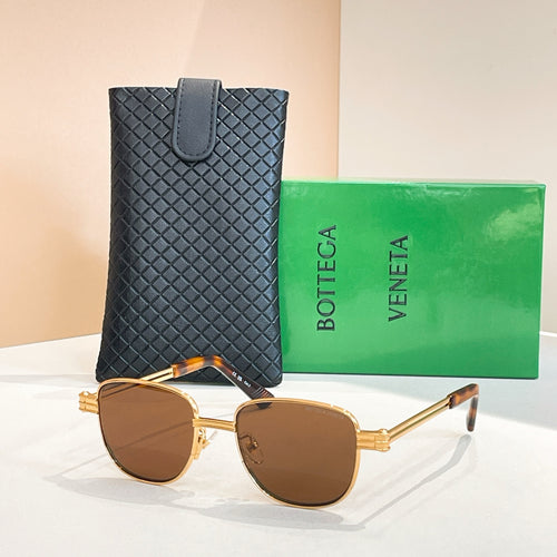Bottega Veneta sunglasses with dark brown lenses, gold-tone round frame and arms.