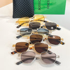 Assorted round sunglasses with gold frames and mixed dark lenses, laid together.