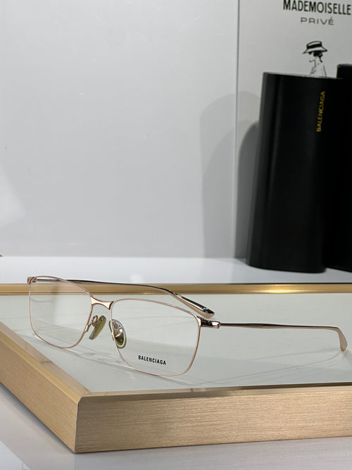 Balenciaga glasses with clear lenses and gold-toned metal frame