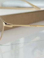 Balenciaga glasses close-up of gold hinge and clear lens