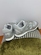 Gray Chanel logo sneakers with white laces, heel and back sole view