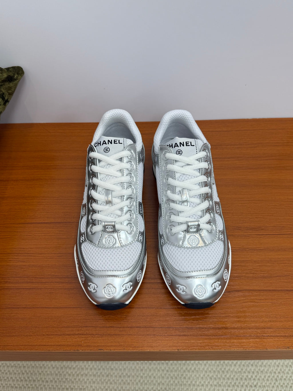 Chanel white low-top sneakers with patterned trim and logo details, white laces.